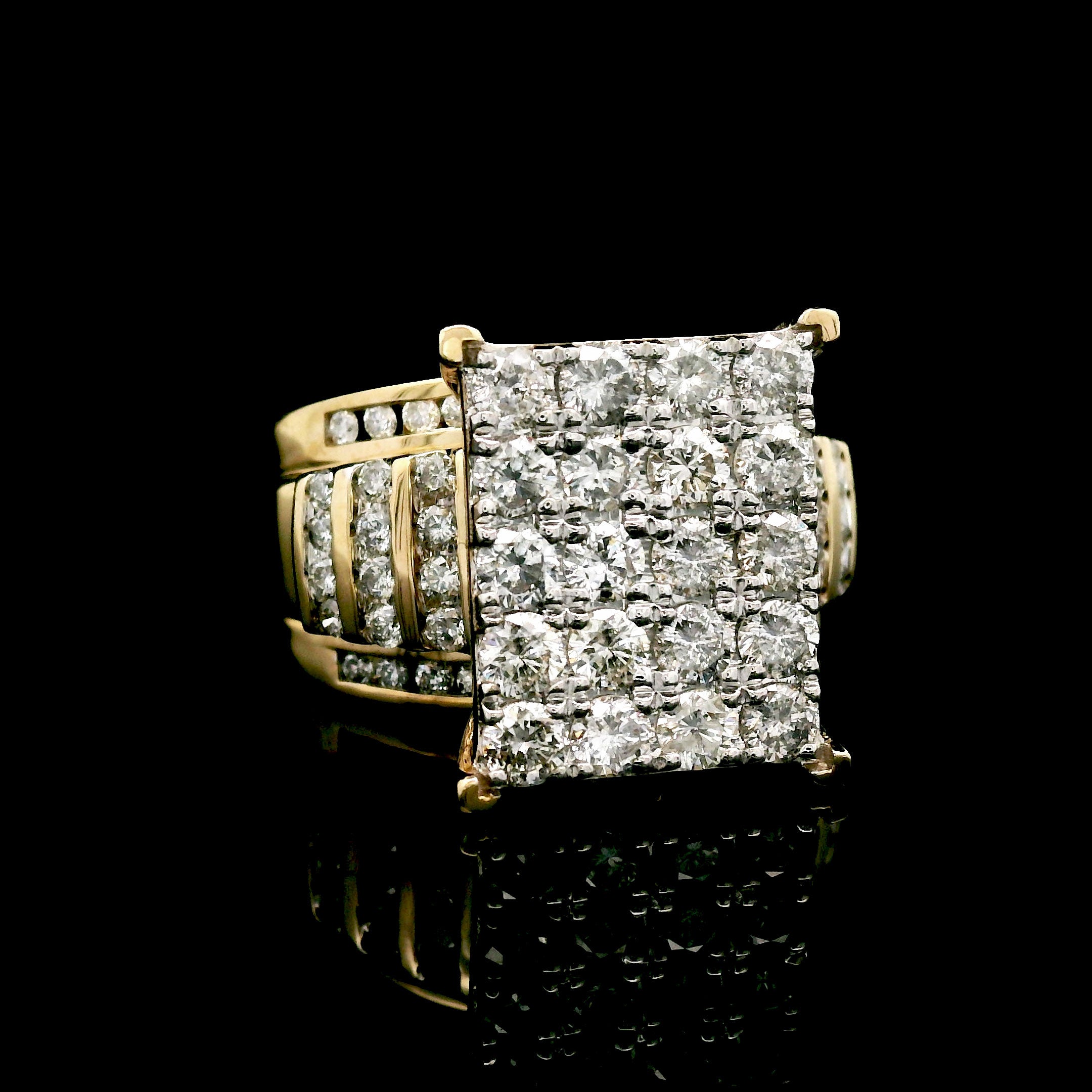 Gold ring with diamond square cluster on a black background left